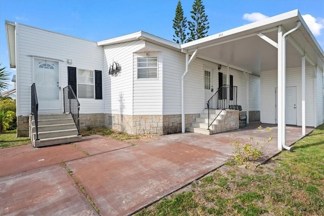 641 Hyacinth Cir, Barefoot Bay, FL 32976 - view of front of house with a carport and entry steps