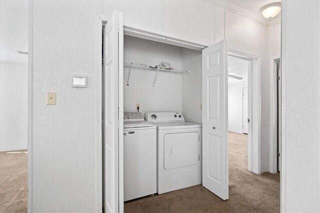 641 Hyacinth Cir, Barefoot Bay, FL 32976 - laundry area with dark carpet, washer and dryer, ornamental molding, and laundry area