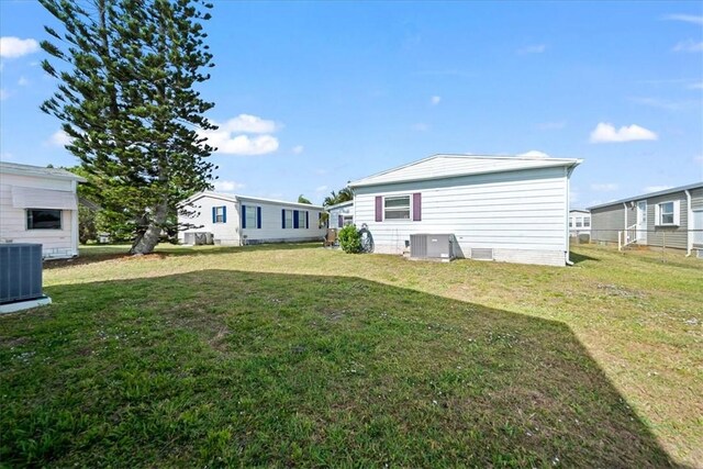 641 Hyacinth Cir, Barefoot Bay, FL 32976 - view of yard with central AC
