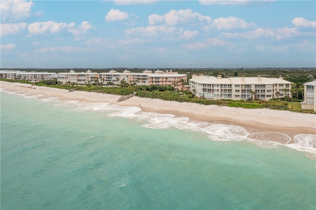 bird's eye view featuring a water view and a beach view