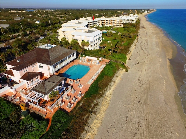 drone / aerial view with a water view and a beach view