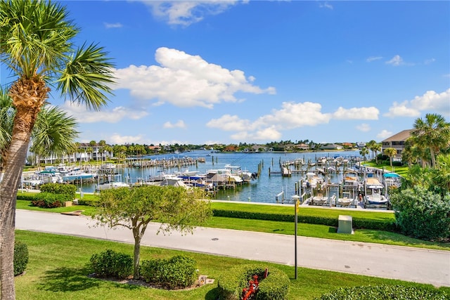 view of dock with a lawn and a water view