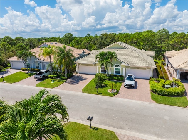 ranch-style home with a garage and a front yard