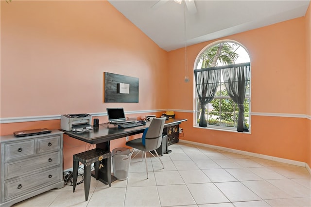 office featuring ceiling fan, light tile patterned floors, and vaulted ceiling