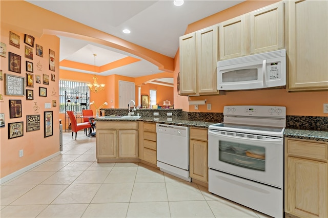 kitchen with light brown cabinets, white appliances, an inviting chandelier, and hanging light fixtures