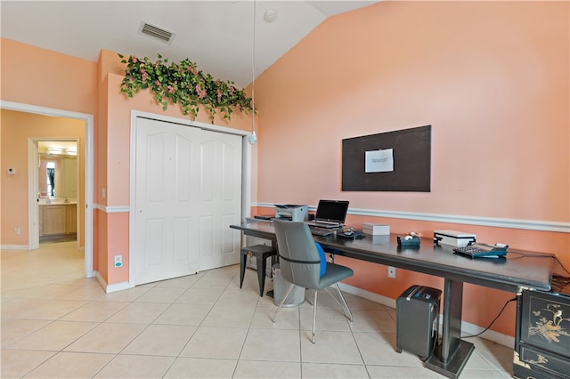 office area featuring lofted ceiling and light tile patterned floors