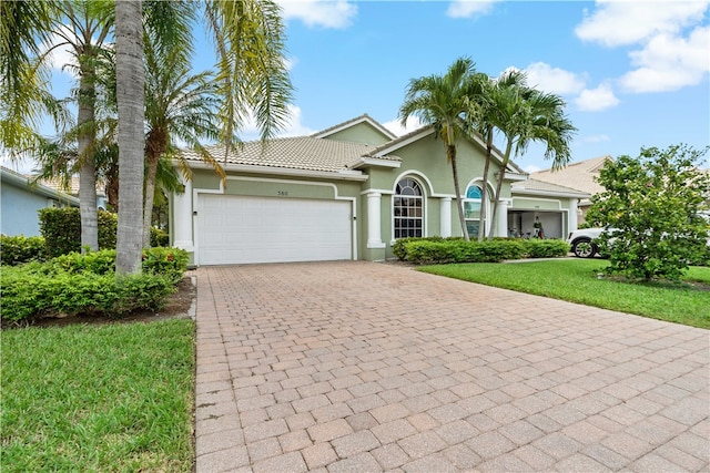 view of front facade with a garage and a front lawn