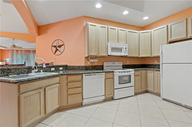 kitchen with kitchen peninsula, light brown cabinetry, white appliances, and sink