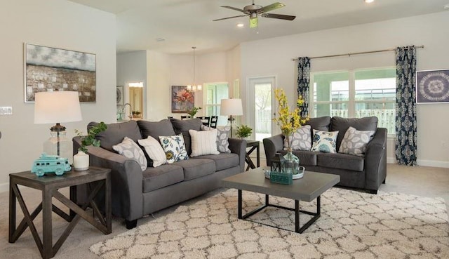 living area featuring recessed lighting, ceiling fan with notable chandelier, carpet, and baseboards