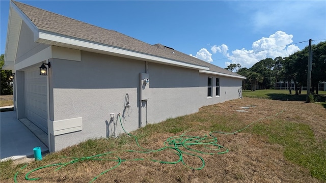 498 Easy St, Sebastian, FL 32958 - view of home's exterior with stucco siding, roof with shingles, and an attached garage