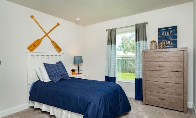 carpeted bedroom with baseboards