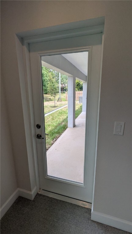498 Easy St, Sebastian, FL 32958 - doorway with carpet floors and baseboards