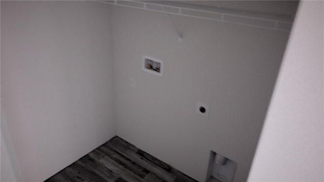 clothes washing area with hookup for an electric dryer, hookup for a washing machine, and dark wood finished floors
