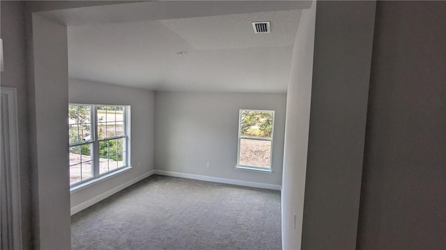 unfurnished room featuring healthy amount of natural light, baseboards, carpet, and lofted ceiling