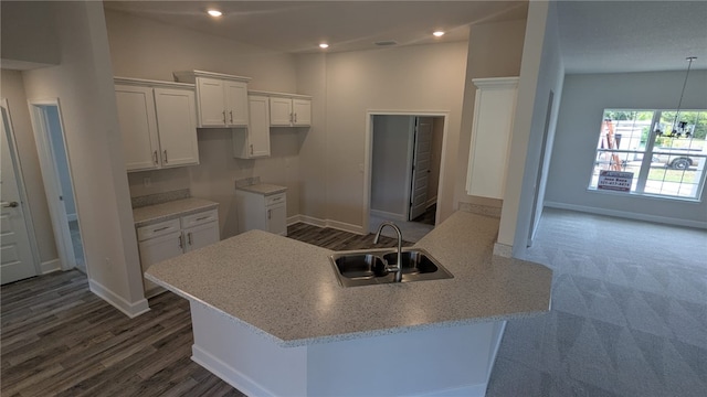 498 Easy St, Sebastian, FL 32958 - kitchen with a sink, white cabinetry, baseboards, a peninsula, and recessed lighting