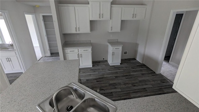 kitchen with white cabinets, a sink, and dark wood-style floors