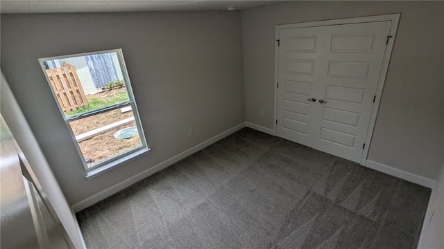 498 Easy St, Sebastian, FL 32958 - empty room with dark carpet and baseboards
