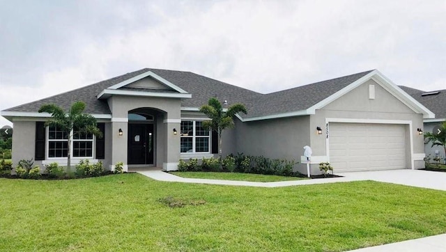 single story home featuring stucco siding, driveway, a front yard, a shingled roof, and a garage