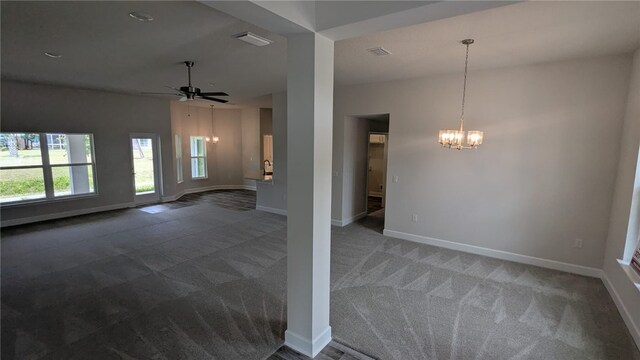 498 Easy St, Sebastian, FL 32958 - unfurnished living room featuring a chandelier, carpet, and healthy amount of natural light