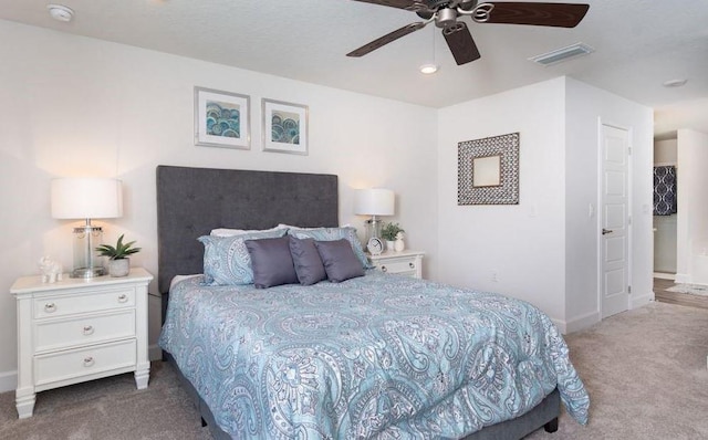 carpeted bedroom with baseboards, visible vents, and ceiling fan