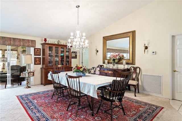 dining room featuring visible vents, baseboards, light colored carpet, vaulted ceiling, and a notable chandelier