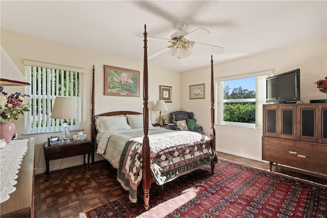 bedroom with baseboards, a textured ceiling, and a ceiling fan