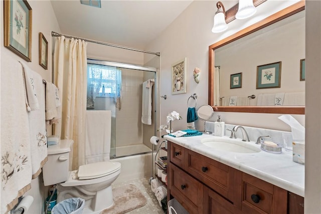 bathroom featuring vanity, tile patterned floors, toilet, and combined bath / shower with glass door