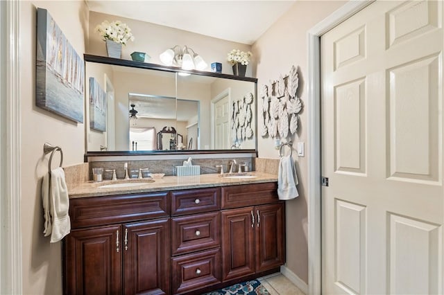 full bath with a sink, ceiling fan, double vanity, and tile patterned flooring