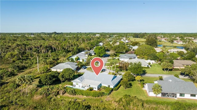 bird's eye view featuring a wooded view