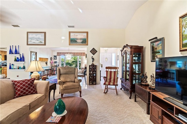 living room with light tile patterned floors, visible vents, and light carpet