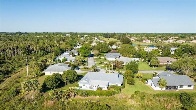 bird's eye view featuring a residential view and a wooded view