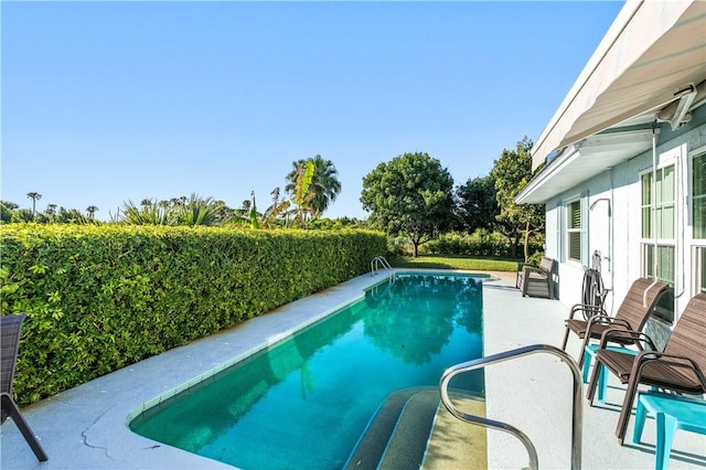 view of swimming pool with a patio and a fenced in pool