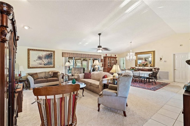 living room featuring visible vents, ceiling fan with notable chandelier, a textured ceiling, and lofted ceiling