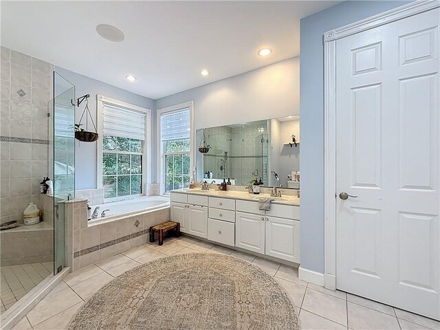 105 Charleston Oaks Dr, Port St Lucie, FL 34983 - full bath featuring tile patterned floors, double vanity, a stall shower, and recessed lighting