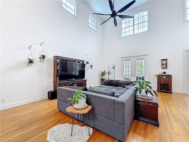 105 Charleston Oaks Dr, Port St Lucie, FL 34983 - living room with ceiling fan, a towering ceiling, light wood finished floors, and french doors