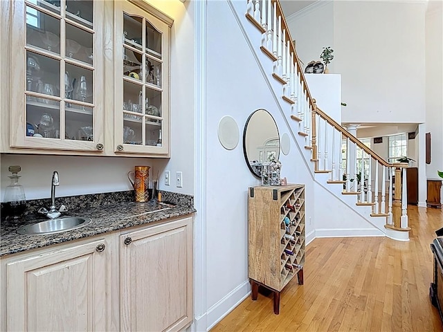 105 Charleston Oaks Dr, Port St Lucie, FL 34983 - indoor wet bar with stairway, baseboards, and light wood-style floors