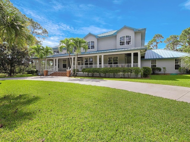 105 Charleston Oaks Dr, Port St Lucie, FL 34983 - view of front of house featuring covered porch, a standing seam roof, a front lawn, and metal roof