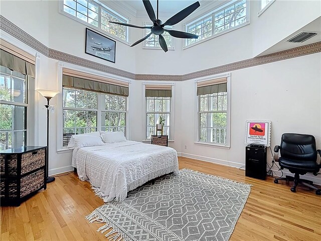 105 Charleston Oaks Dr, Port St Lucie, FL 34983 - bedroom featuring a high ceiling, wood finished floors, and multiple windows