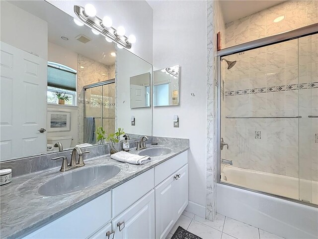 105 Charleston Oaks Dr, Port St Lucie, FL 34983 - bathroom featuring shower / bath combination with glass door, double vanity, marble finish flooring, and baseboards