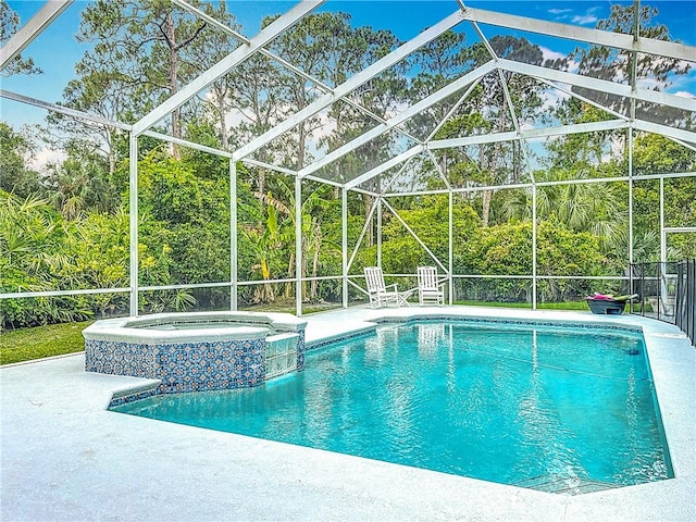 105 Charleston Oaks Dr, Port St Lucie, FL 34983 - view of swimming pool featuring a patio, a pool with connected hot tub, and glass enclosure