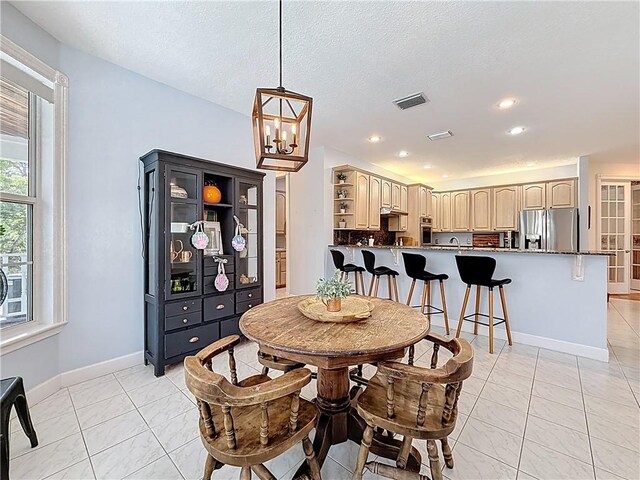 105 Charleston Oaks Dr, Port St Lucie, FL 34983 - dining area with baseboards, a chandelier, recessed lighting, and a textured ceiling