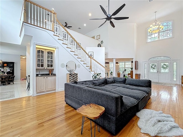 105 Charleston Oaks Dr, Port St Lucie, FL 34983 - living area featuring a towering ceiling, light wood-style floors, plenty of natural light, and stairs