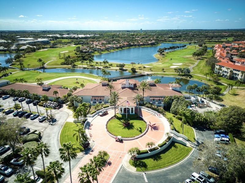 drone / aerial view with view of golf course and a water view