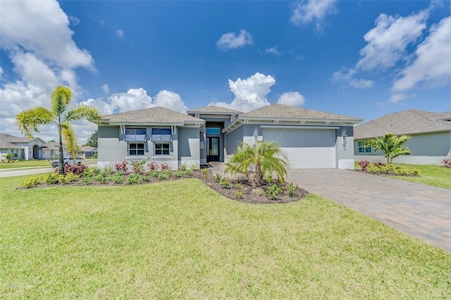 view of front of property featuring a garage and a front yard