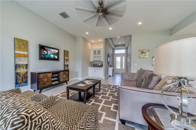 living room featuring ceiling fan and light tile patterned floors