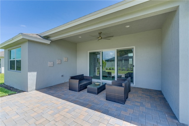 view of patio with ceiling fan and an outdoor living space