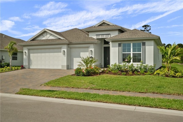 view of front of house featuring a garage and a front lawn