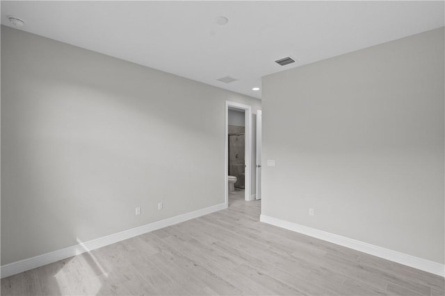 empty room with light hardwood / wood-style floors