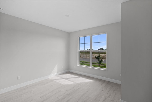 spare room featuring light hardwood / wood-style flooring