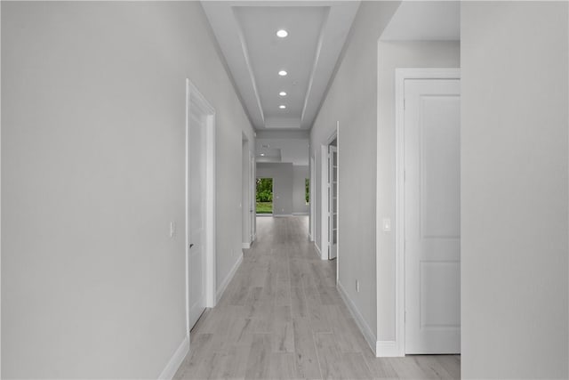 hallway with light hardwood / wood-style floors